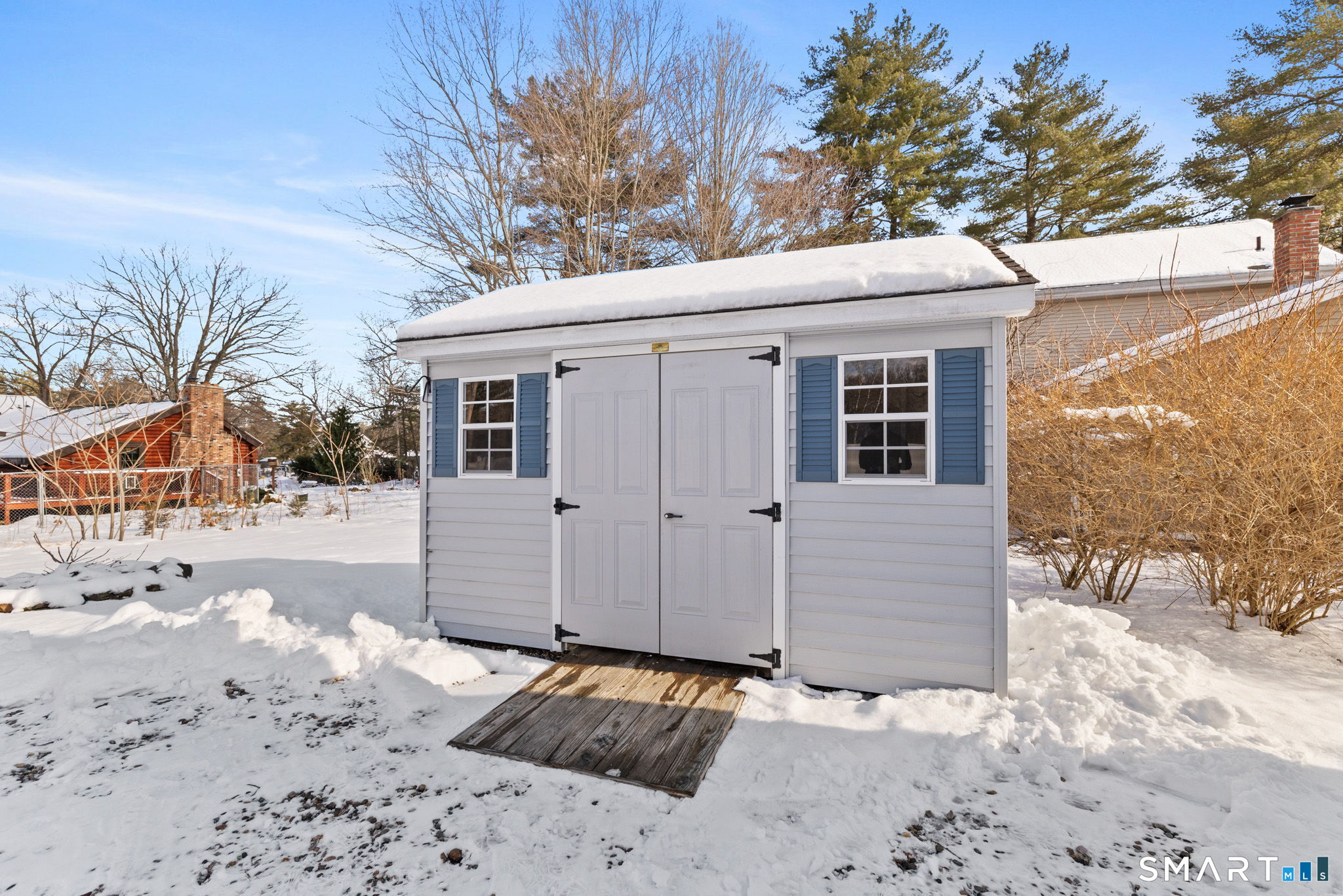 10 School Street Burlington, CT 06013 - Photo 6 of 35 a view of a house with a snow on the road