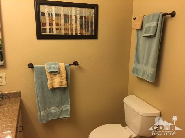 63 Torremolinos Drive Rancho Mirage, CA 92270 - Photo 14 of 32 a white toilet sitting next to a bathroom sink