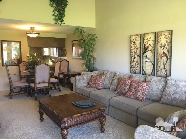 a living room with furniture and a large mirror