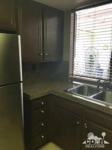 a kitchen with a sink and a refrigerator