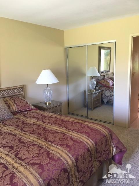 63 Torremolinos Drive Rancho Mirage, CA 92270 - Photo 9 of 32 a bedroom with a bed and wooden floor