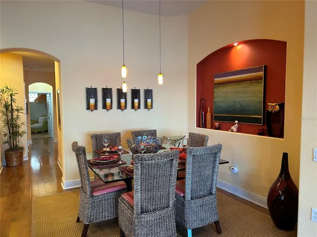 a dining room with furniture and wooden floor