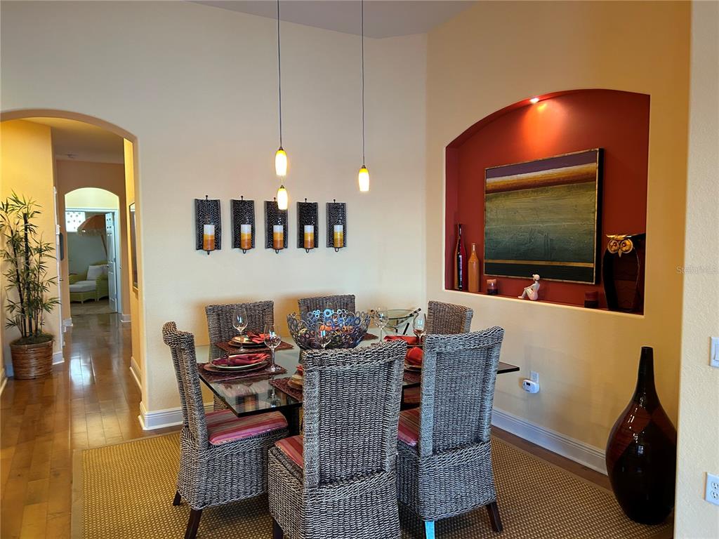 1139 Riverscape Street, Unit 1139 Bradenton, FL 34208 - Photo 12 of 45 a dining room with furniture and wooden floor