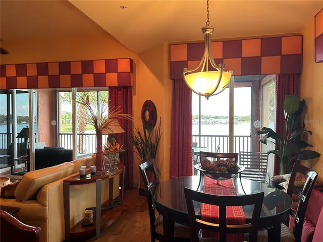 a view of a dining room with furniture and chandelier