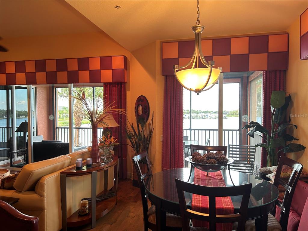 1139 Riverscape Street, Unit 1139 Bradenton, FL 34208 - Photo 14 of 45 a view of a dining room with furniture and chandelier