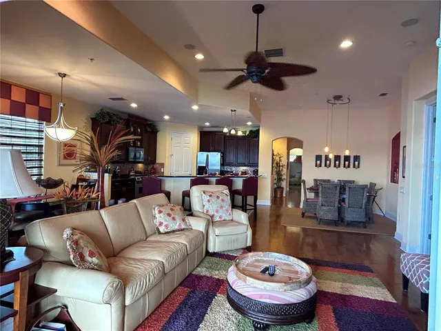 a living room with furniture and a chandelier