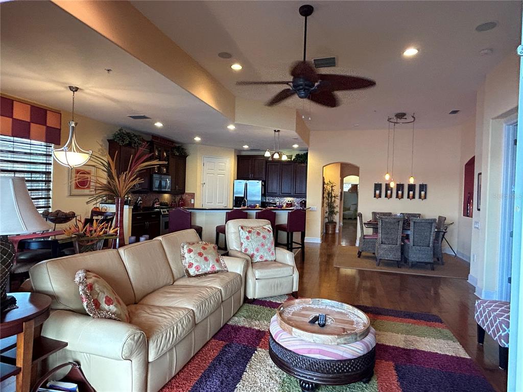 1139 Riverscape Street, Unit 1139 Bradenton, FL 34208 - Photo 16 of 45 a living room with furniture and a chandelier
