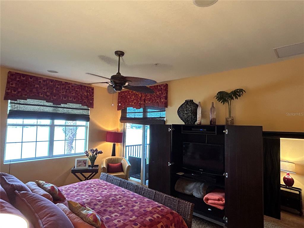 1139 Riverscape Street, Unit 1139 Bradenton, FL 34208 - Photo 19 of 45 a living room with furniture a window and a fireplace