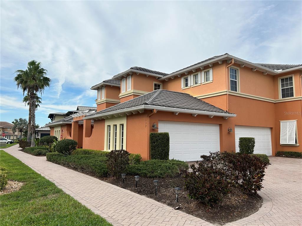 1139 Riverscape Street, Unit 1139 Bradenton, FL 34208 - Photo 2 of 45 a front view of a house with a yard and garage