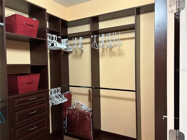 a bathroom with a sink a toilet a mirror and shower