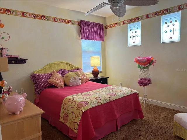 a bedroom with two beds and a window