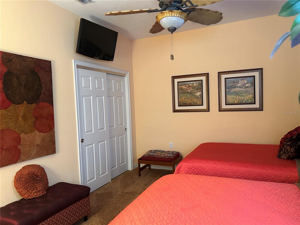 1139 Riverscape Street, Unit 1139 Bradenton, FL 34208 - Photo 32 of 45 a bedroom with a bed and a television