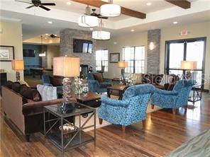 1139 Riverscape Street, Unit 1139 Bradenton, FL 34208 - Photo 40 of 45 a living room with fireplace furniture and a chandelier