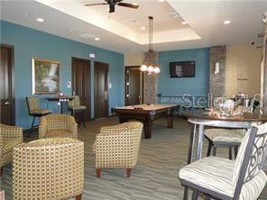 1139 Riverscape Street, Unit 1139 Bradenton, FL 34208 - Photo 41 of 45 a living room with furniture a chandelier and a dining table