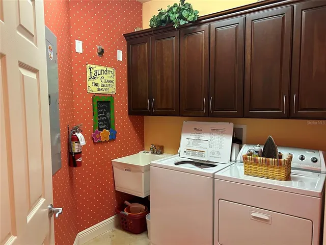 a room with a refrigerator and cabinets