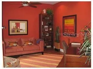 a living room with furniture and wooden floor