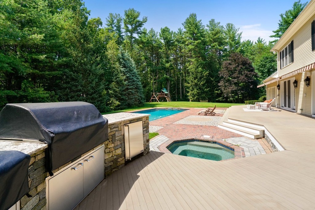 219 B Ipswich Road Boxford, MA 01921 - Photo 6 of 30 a view of a backyard with lawn chairs potted plants and large tree