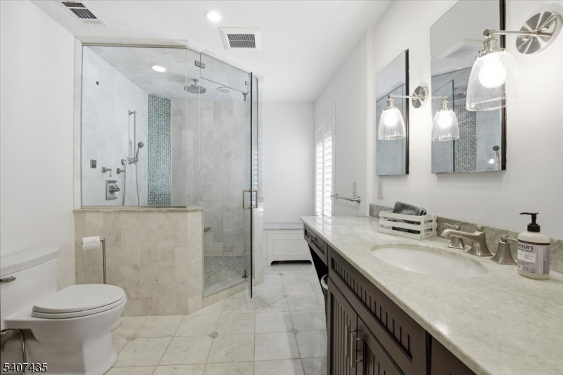 139 Riveredge Drive, Unit 139 Chatham, NJ 07928 - Photo 17 of 32 a bathroom with a sink toilet and shower