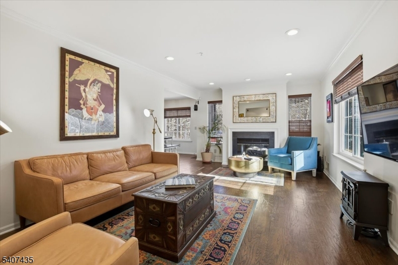 139 Riveredge Drive, Unit 139 Chatham, NJ 07928 - Photo 2 of 32 a living room with fireplace furniture and a flat screen tv