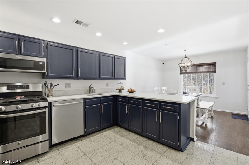 139 Riveredge Drive, Unit 139 Chatham, NJ 07928 - Photo 7 of 32 a kitchen with a sink stove and cabinets