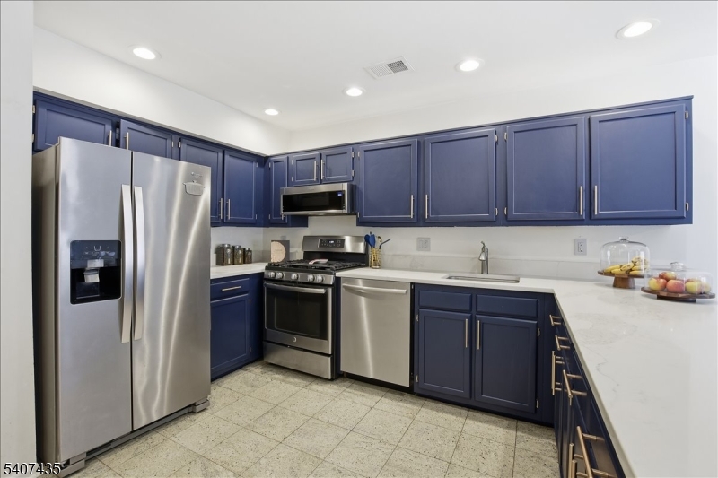 139 Riveredge Drive, Unit 139 Chatham, NJ 07928 - Photo 9 of 32 a kitchen with stainless steel appliances granite countertop a refrigerator stove and sink