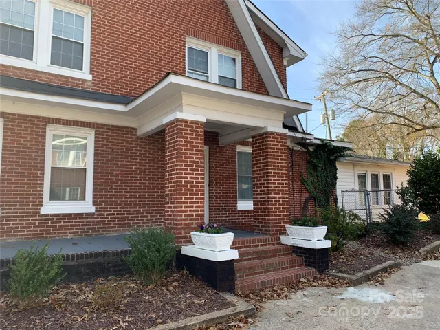 a front view of house and yard with seating space