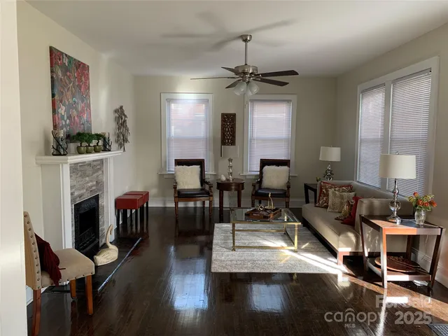 a living room with fireplace furniture and a wooden floor