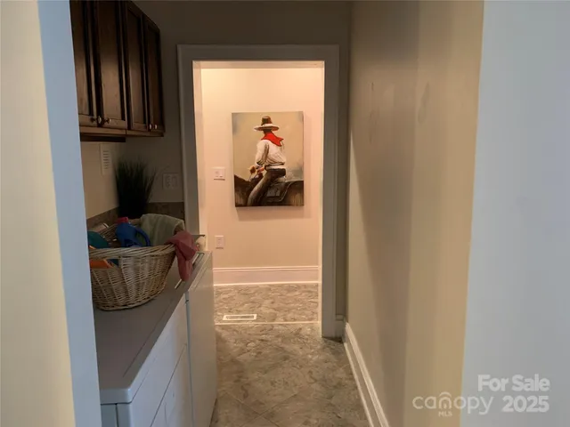 a hallway with a view of bedroom with a sink