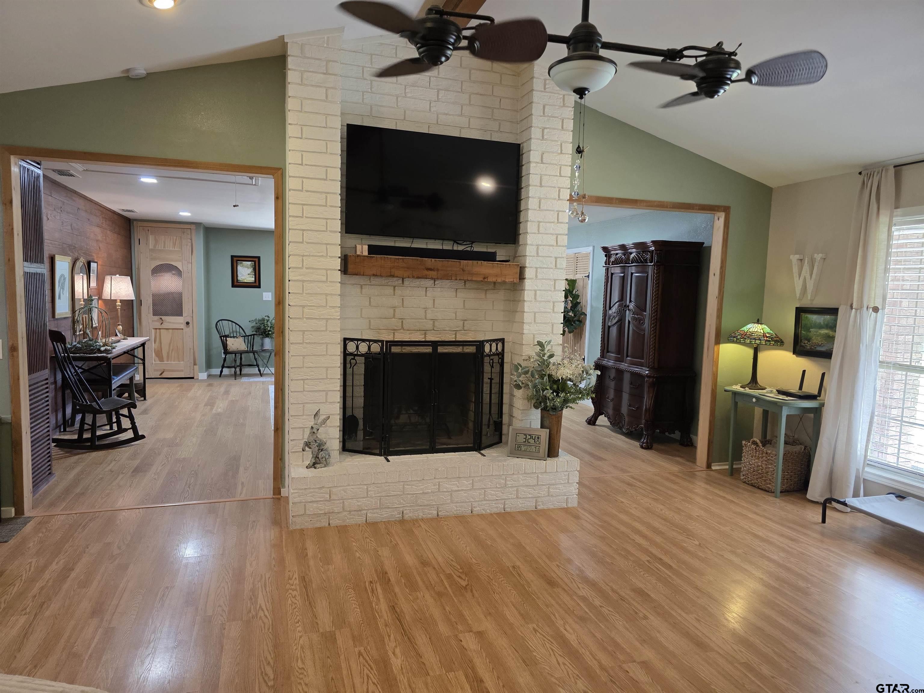 6170 Highway 271 Mount Pleasant, TX 75455 - Photo 12 of 43 a living room with furniture a flat screen tv and a fireplace