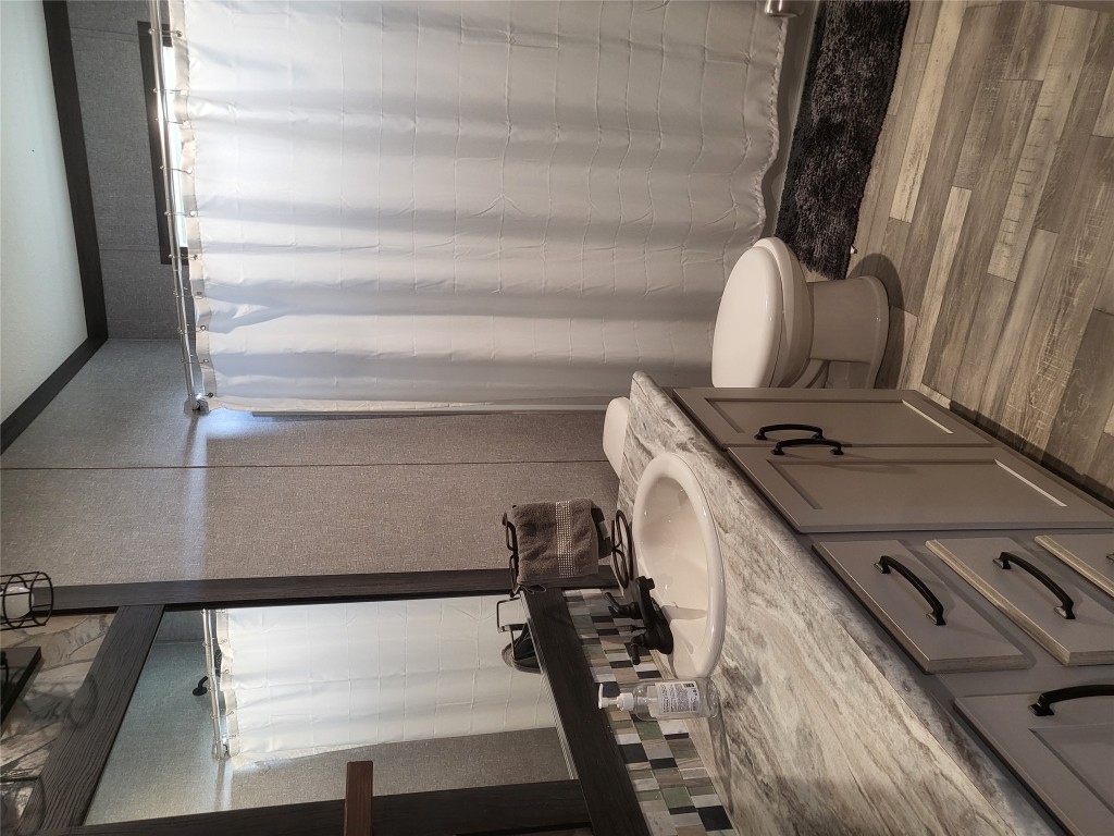 192 Lazy River Lane Elgin, TX 78621 - Photo 11 of 12 Full bathroom with light wood finished floors, curtained shower, vanity, and ornamental molding