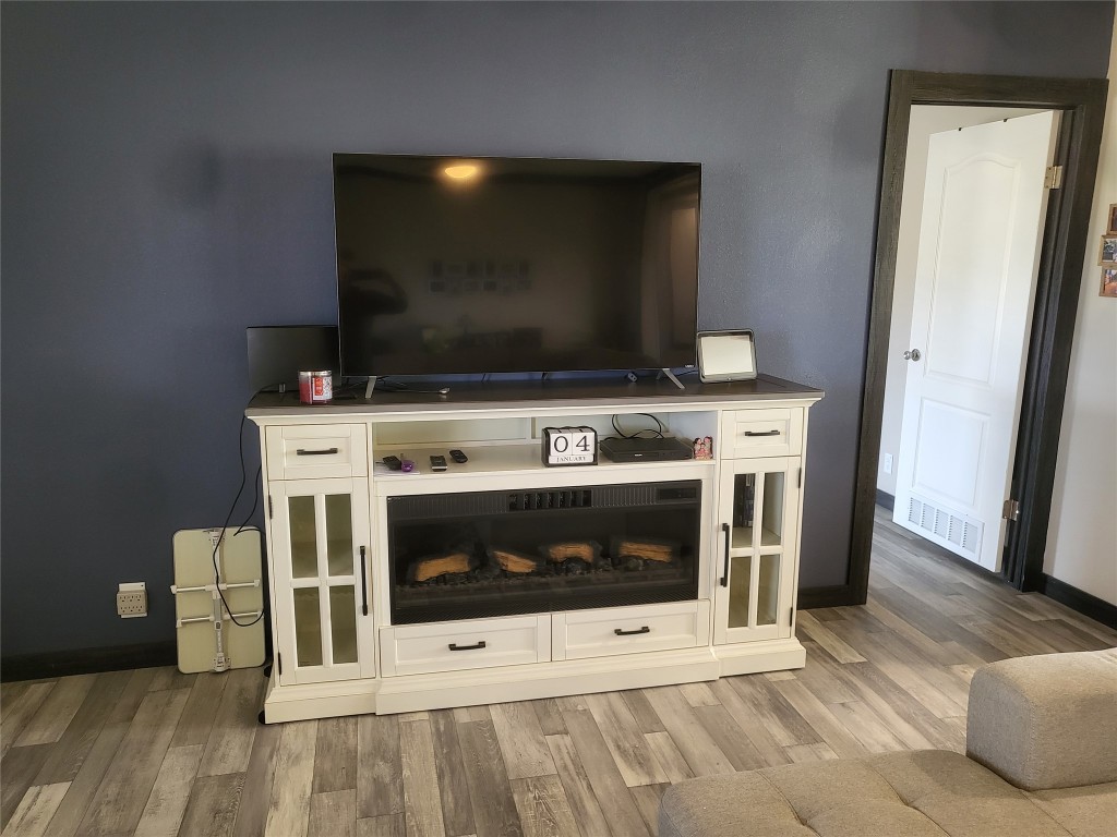 192 Lazy River Lane Elgin, TX 78621 - Photo 6 of 12 Detailed view of wood finished floors and baseboards
