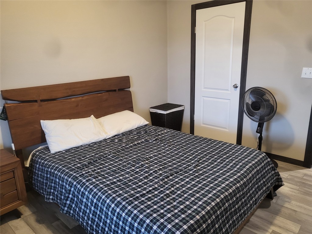 192 Lazy River Lane Elgin, TX 78621 - Photo 10 of 12 Bedroom featuring light wood-style floors and baseboards