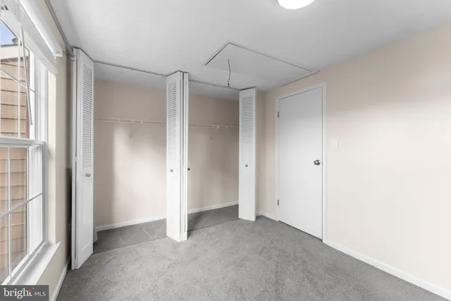 a view of a room with an empty space and a window