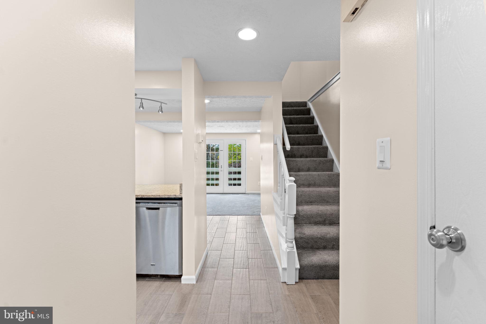 1644 Fieldthorn Drive Reston, VA 20194 - Photo 3 of 43 a view of hallway with stairs and wooden floor