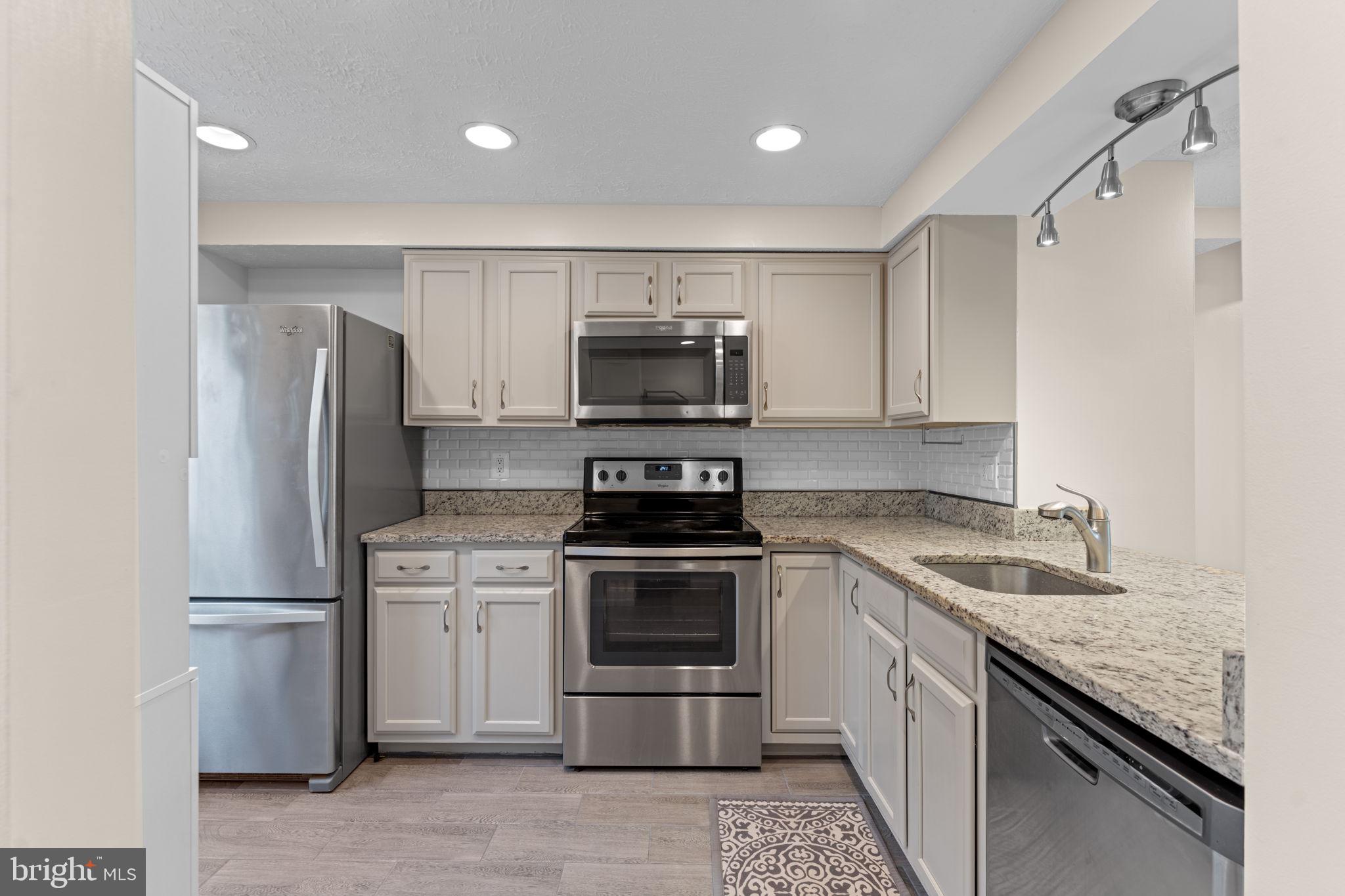 1644 Fieldthorn Drive Reston, VA 20194 - Photo 6 of 43 a kitchen with a stove and a refrigerator