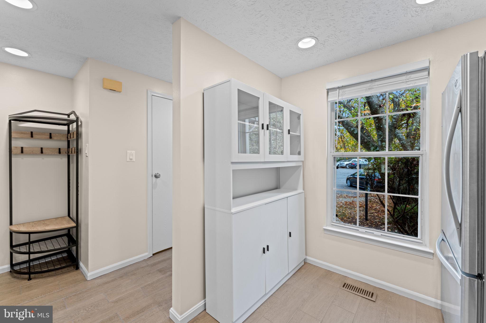 1644 Fieldthorn Drive Reston, VA 20194 - Photo 8 of 43 an entryway with wooden floor and cabinet