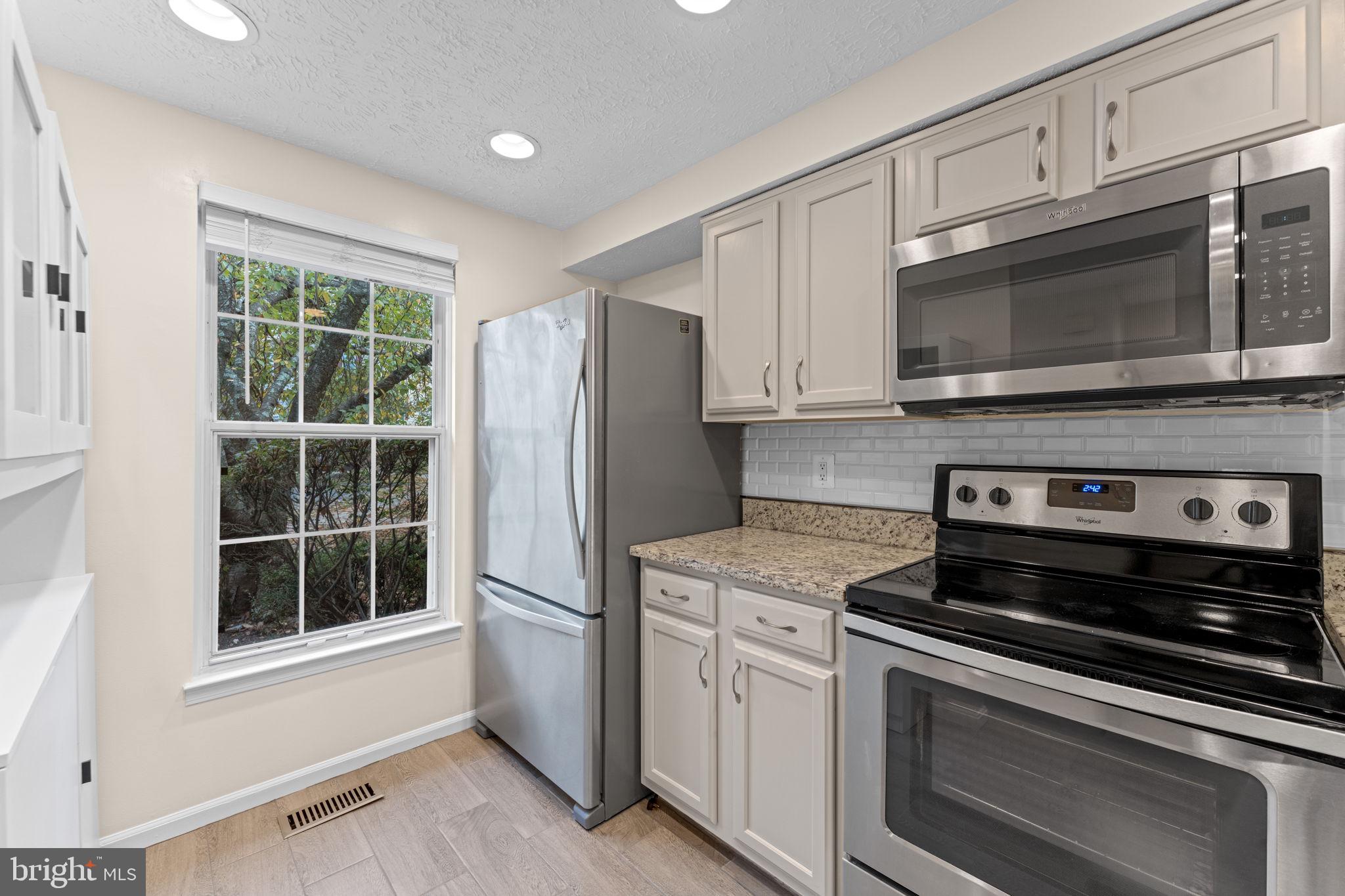 1644 Fieldthorn Drive Reston, VA 20194 - Photo 9 of 43 a kitchen with stainless steel appliances white cabinets stove and a sink