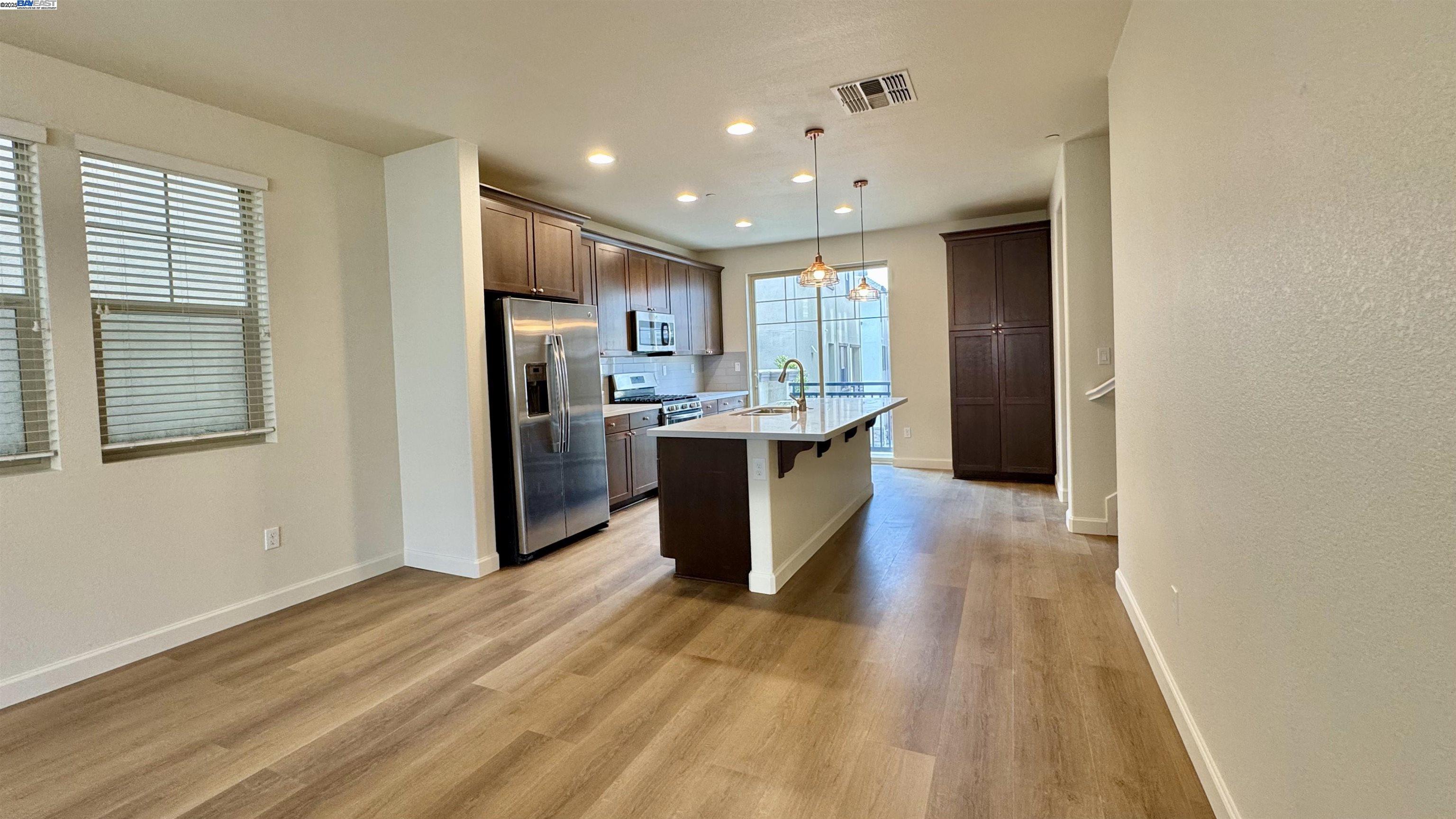 2906 Worthing Common Livermore, CA 94550 - Photo 15 of 31 a kitchen with stainless steel appliances granite countertop a sink stove and refrigerator