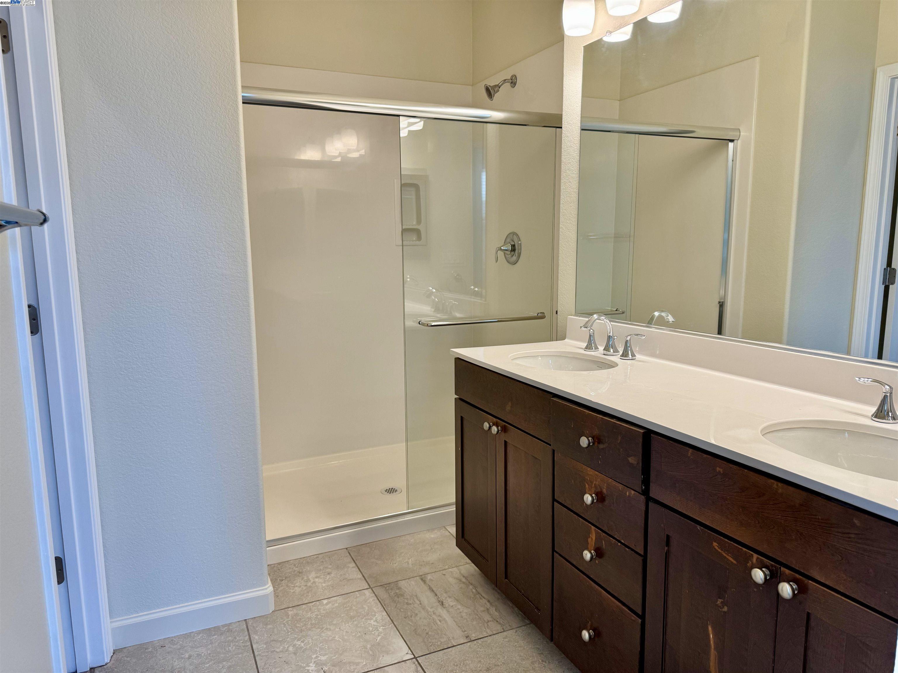 2906 Worthing Common Livermore, CA 94550 - Photo 20 of 31 a bathroom with a double vanity sink mirror and shower