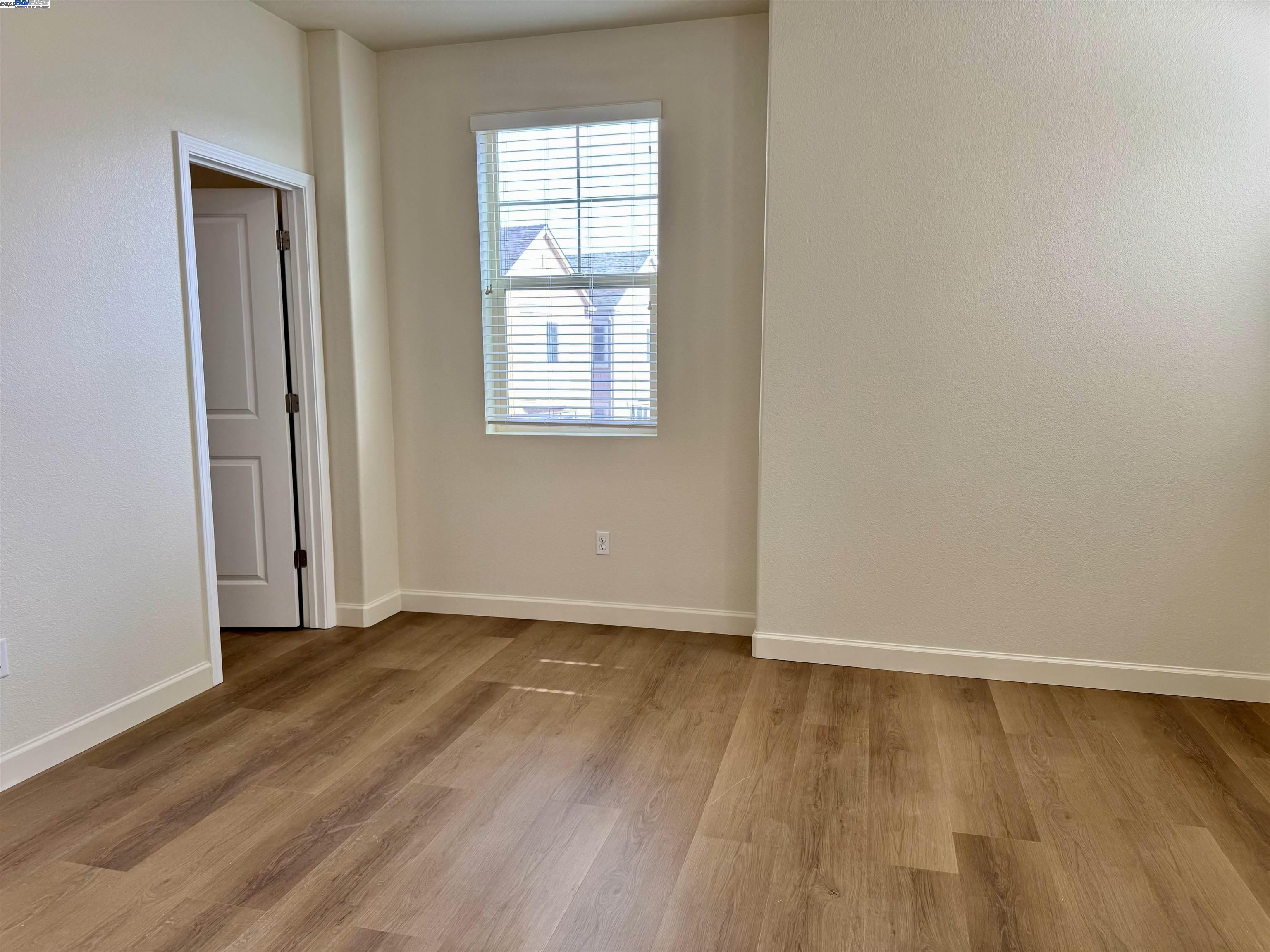 2906 Worthing Common Livermore, CA 94550 - Photo 21 of 31 an empty room with wooden floor and windows