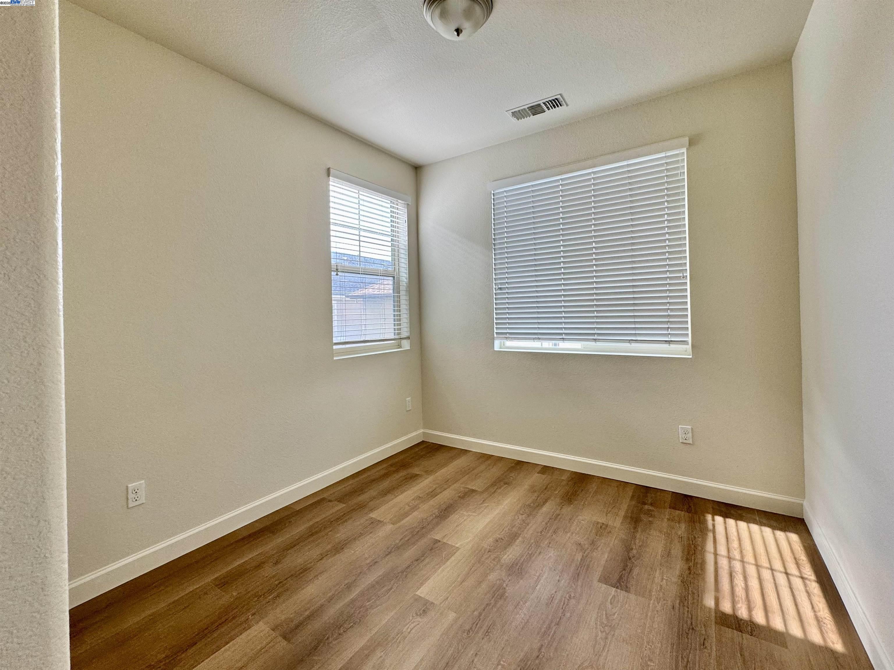 2906 Worthing Common Livermore, CA 94550 - Photo 26 of 31 an empty room with wooden floor and windows