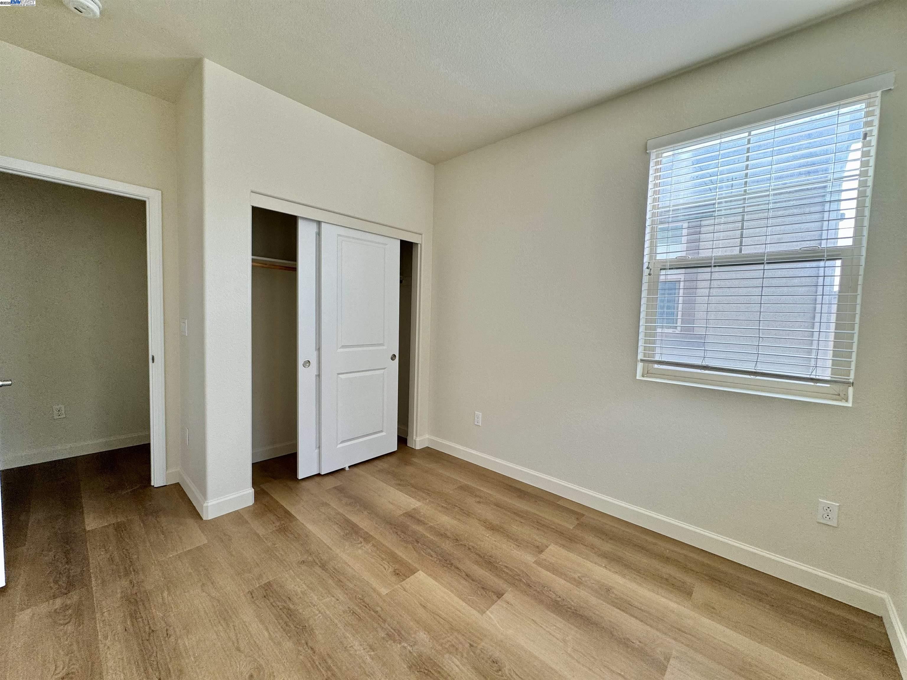 2906 Worthing Common Livermore, CA 94550 - Photo 27 of 31 an empty room with wooden floor and windows