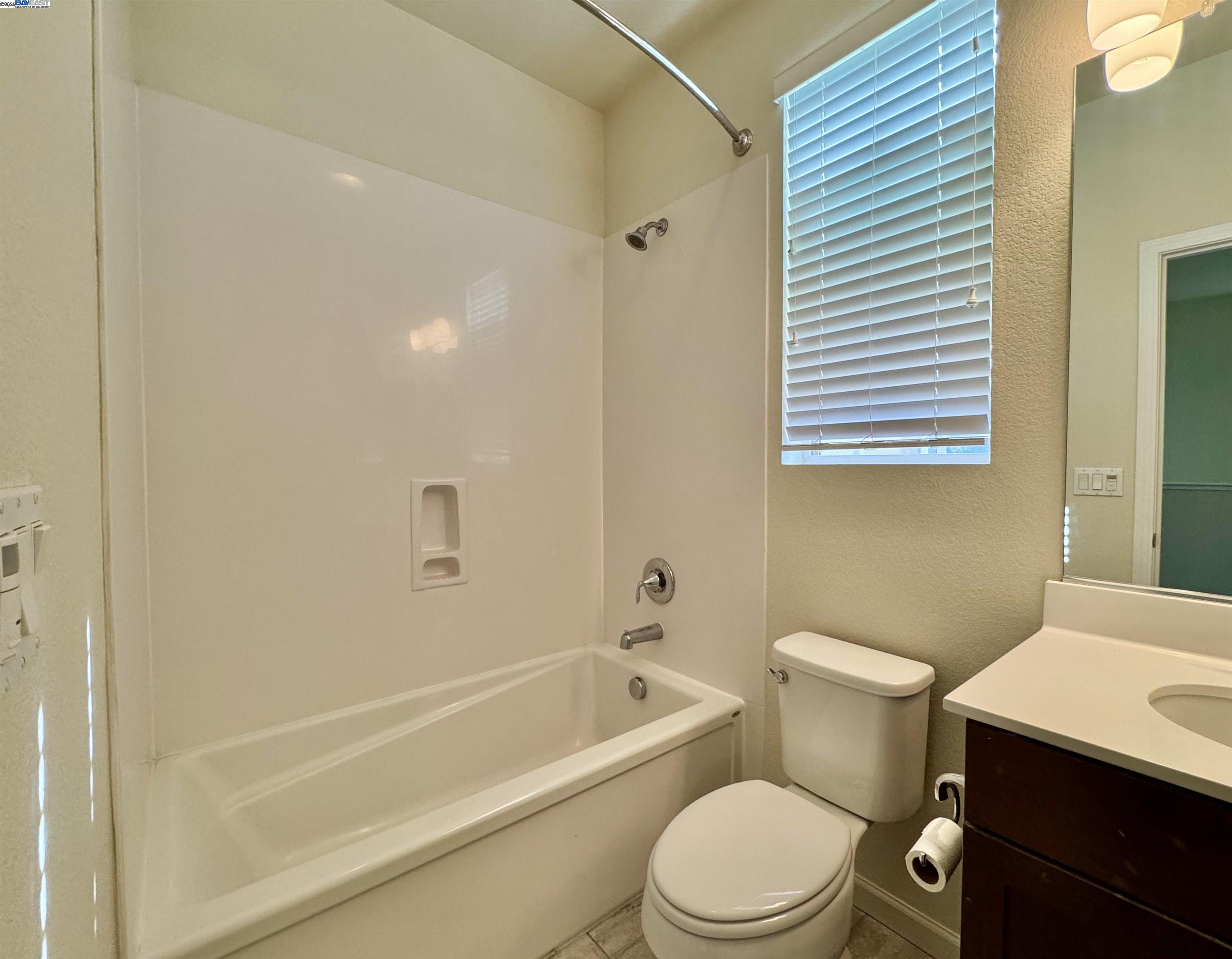 2906 Worthing Common Livermore, CA 94550 - Photo 28 of 31 a white toilet and tub sitting next to a bathroom sink