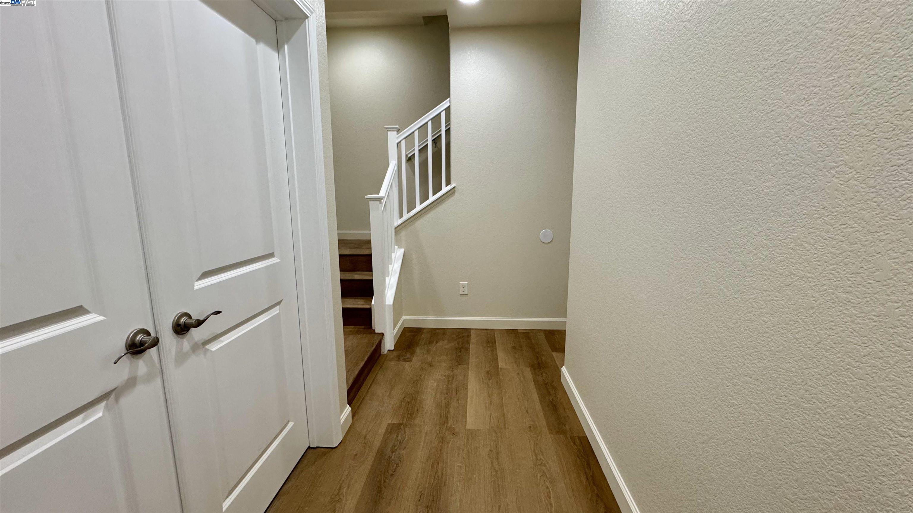 2906 Worthing Common Livermore, CA 94550 - Photo 6 of 31 a view of a hallway with wooden floor and staircase