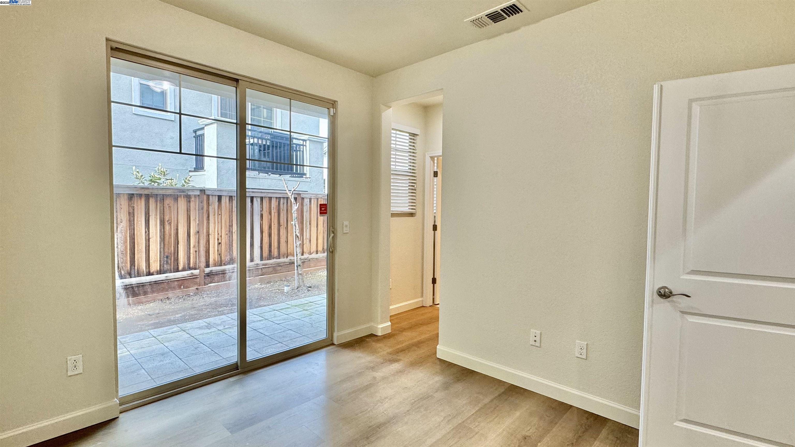 2906 Worthing Common Livermore, CA 94550 - Photo 7 of 31 an empty room with wooden floor and windows