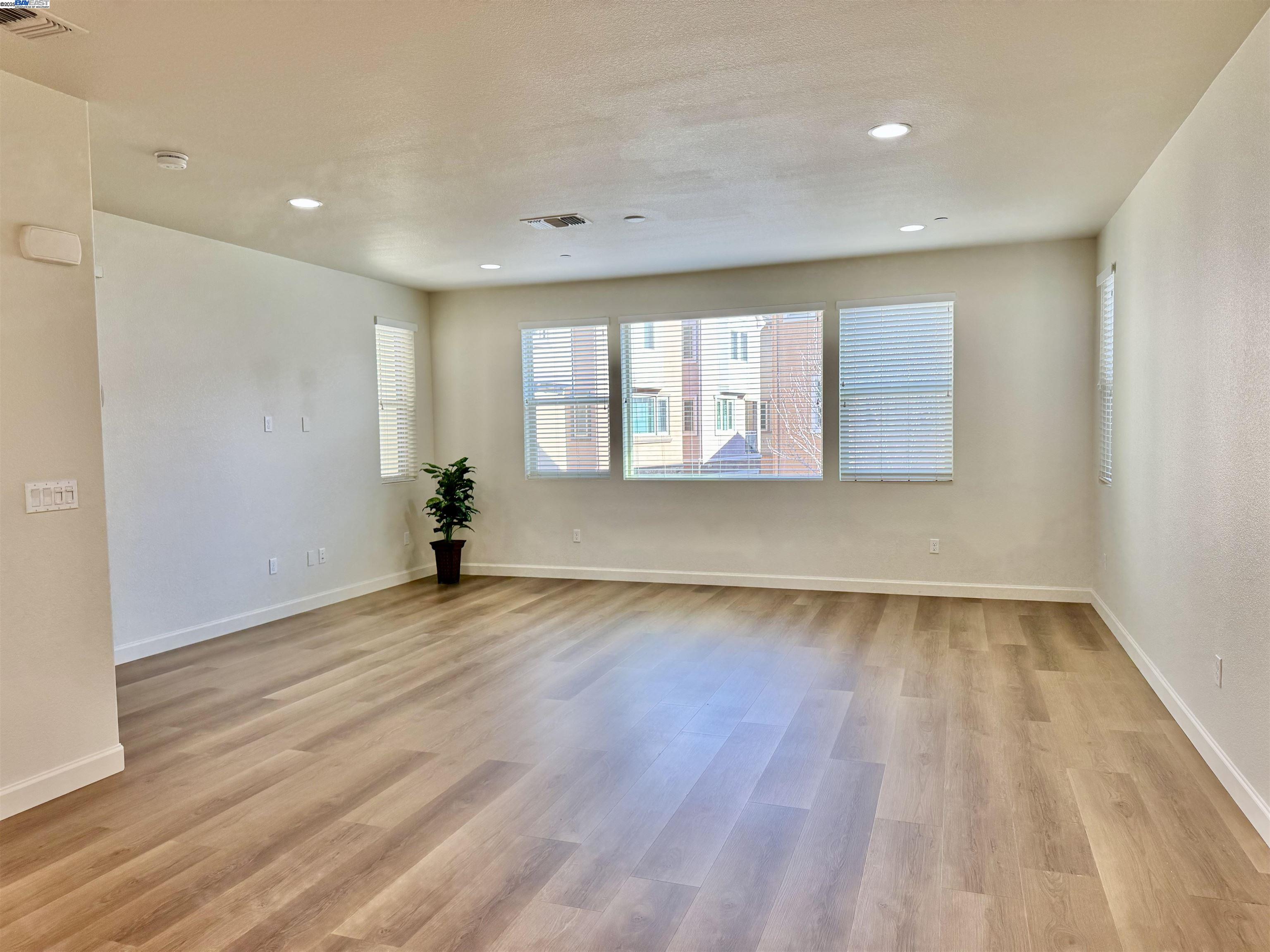 2906 Worthing Common Livermore, CA 94550 - Photo 10 of 31 an empty room with wooden floor and windows