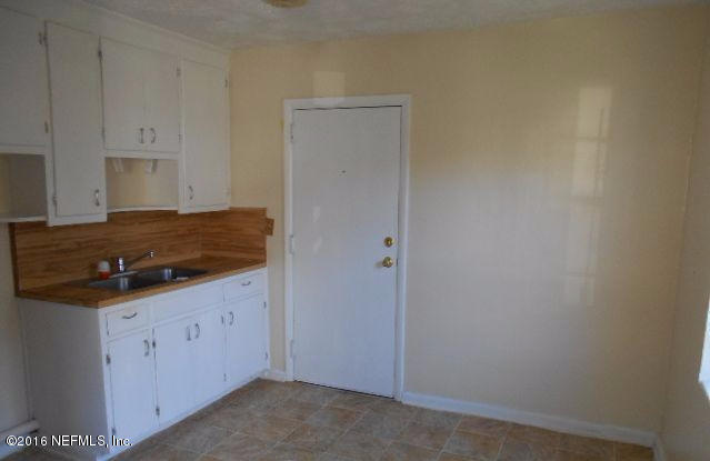 3635 Freeman Road Jacksonville, FL 32207 - Photo 6 of 13 a kitchen with granite countertop cabinets and stove