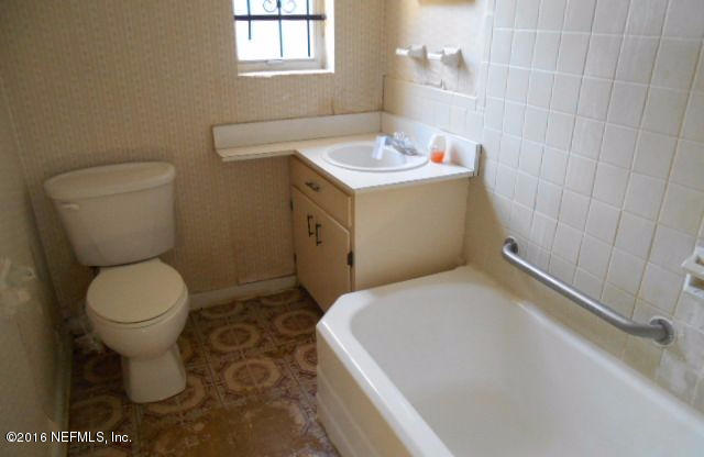 3635 Freeman Road Jacksonville, FL 32207 - Photo 10 of 13 a bathroom with a sink a toilet and a mirror