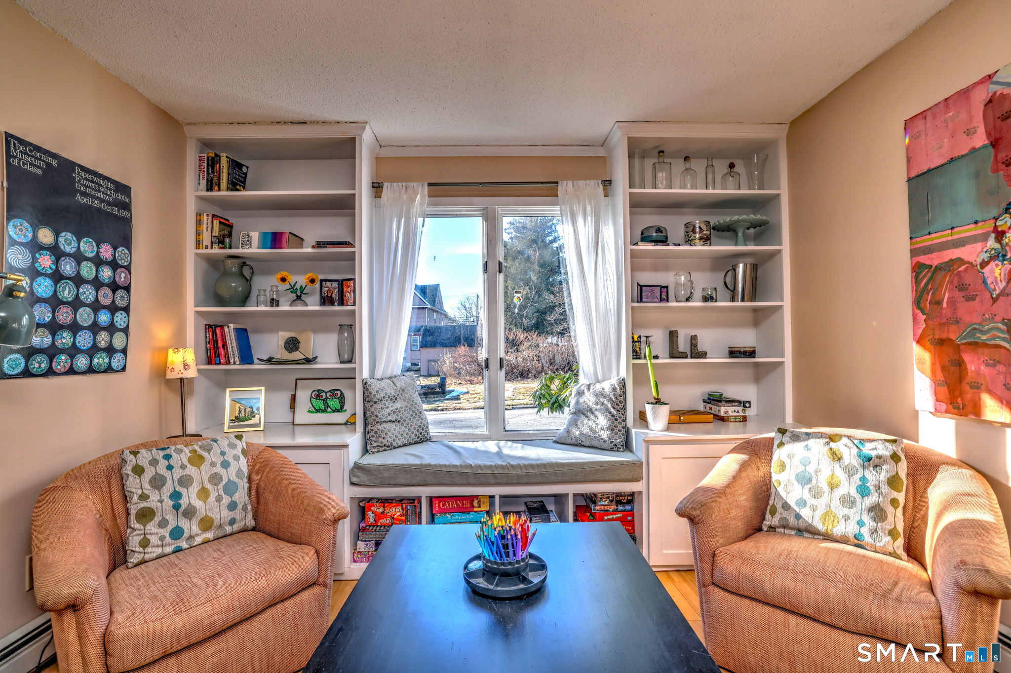 67 Hauser Street Milford, CT 06460 - Photo 12 of 40 a living room with furniture and a book shelf