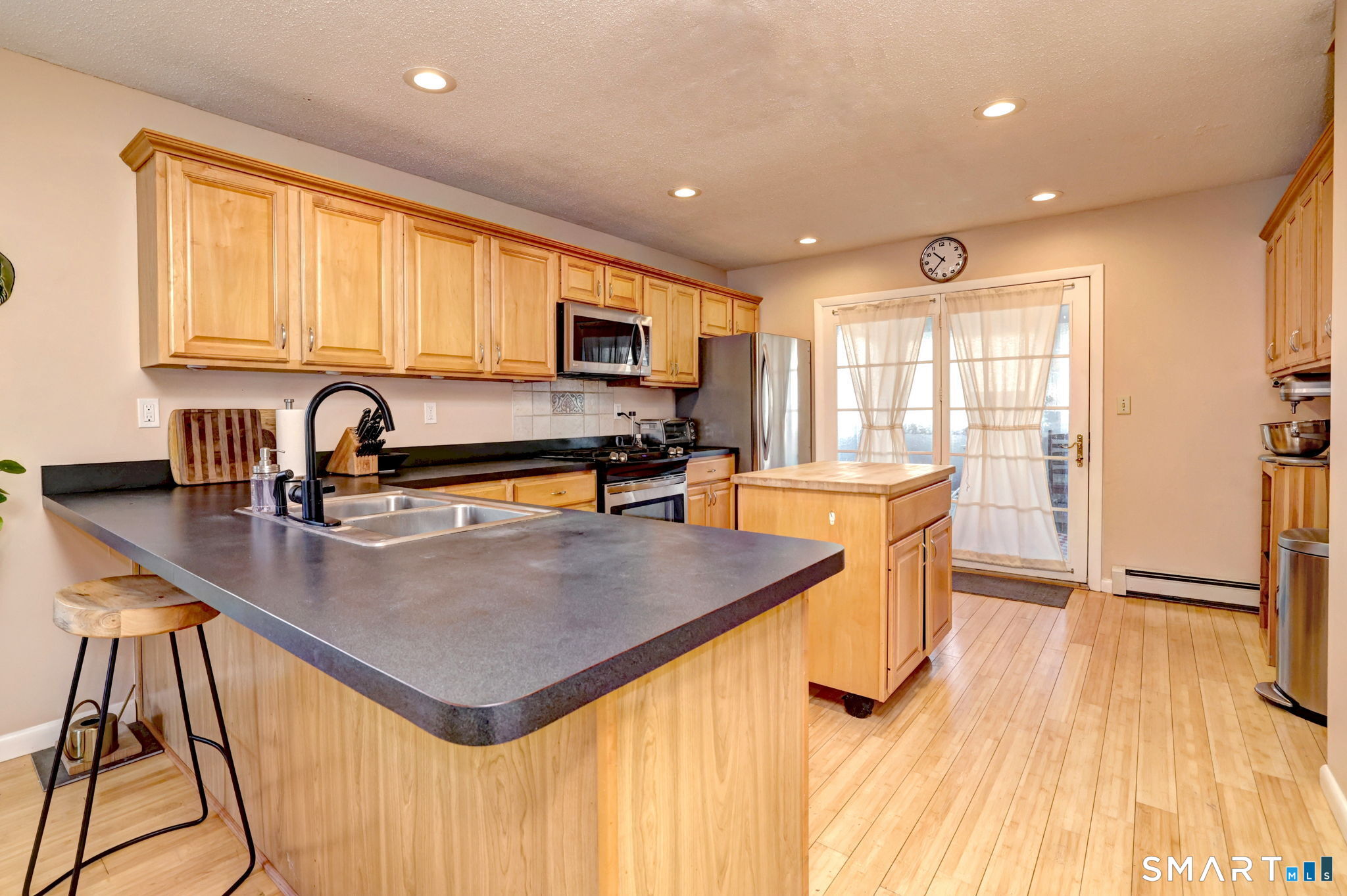 67 Hauser Street Milford, CT 06460 - Photo 14 of 40 a kitchen with stainless steel appliances granite countertop a sink a stove and a refrigerator